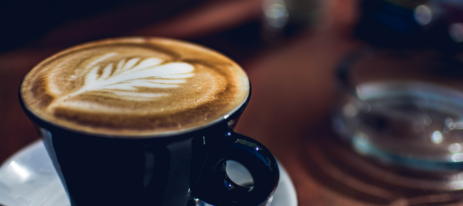 Warm Mocha Drink with a Golden Crema Inside a Cozy Cafe