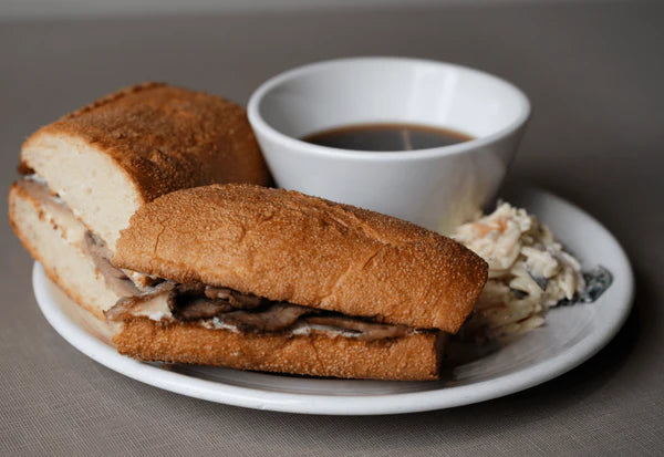 French Dipper sandwich served with a side of Au Jus