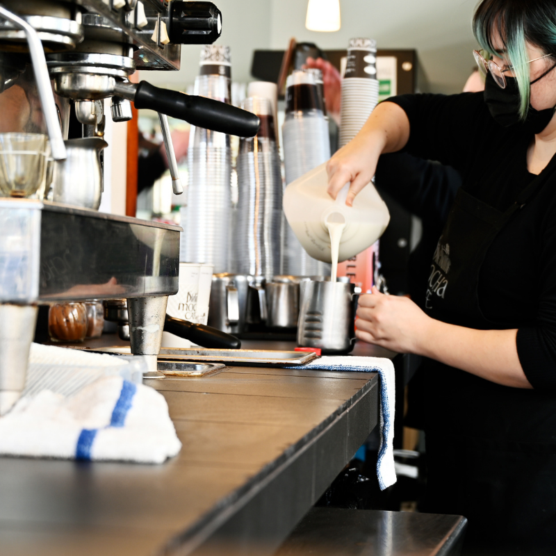 Dilettante Mocha Café barista pouring milk into coffee