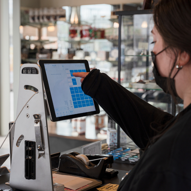 Dilettante Mocha Café barista working a cash register at Kent Station